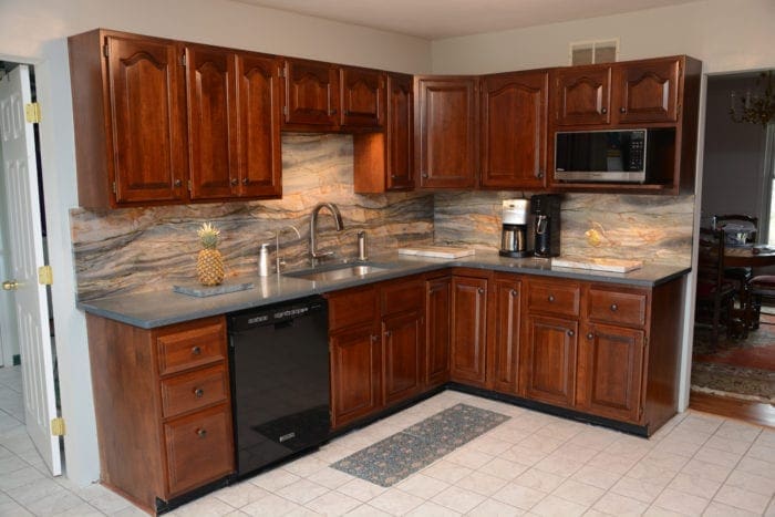 grey granite countertops with brown cabinets